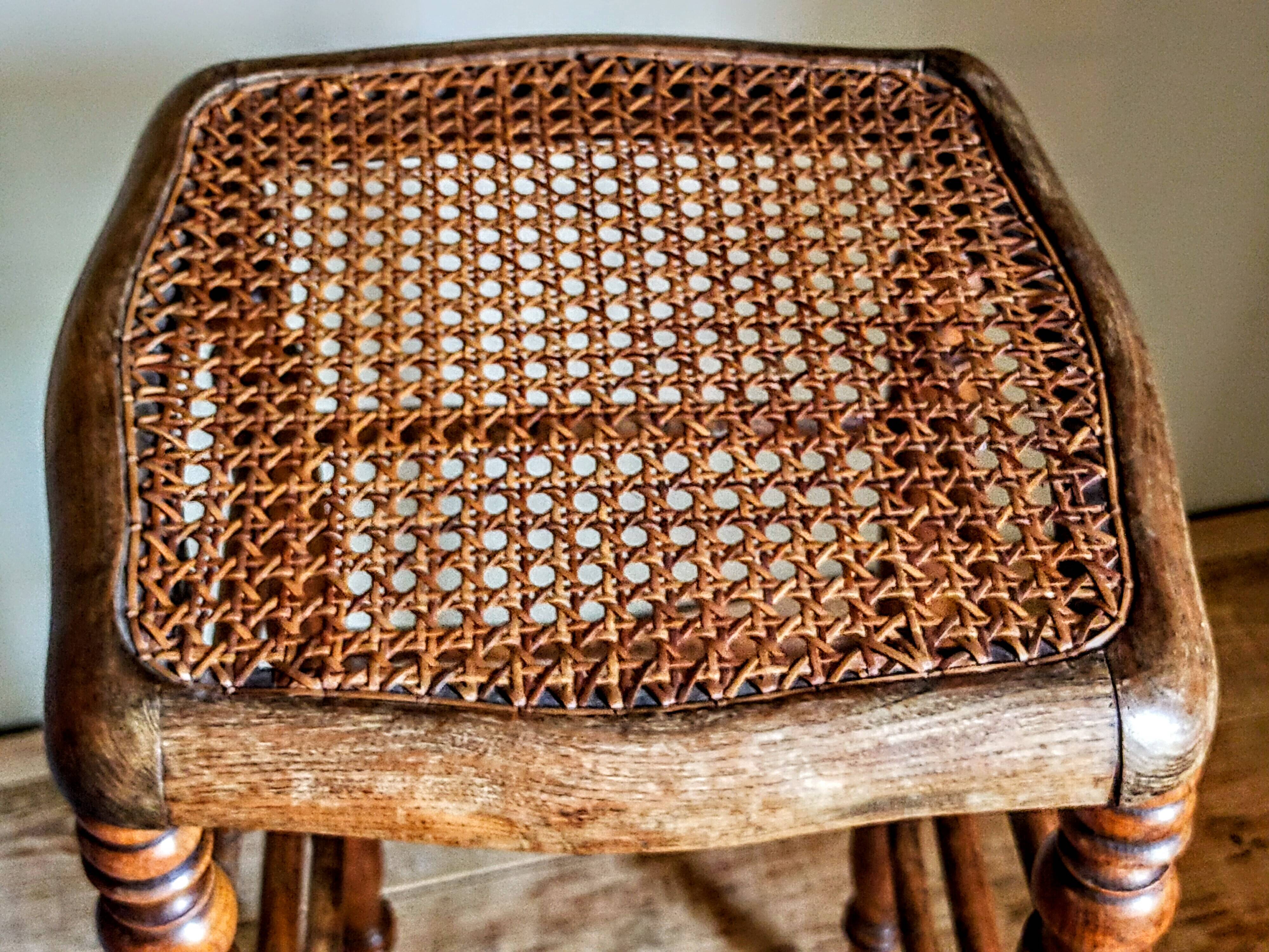 Antique stool with cane and turned wood