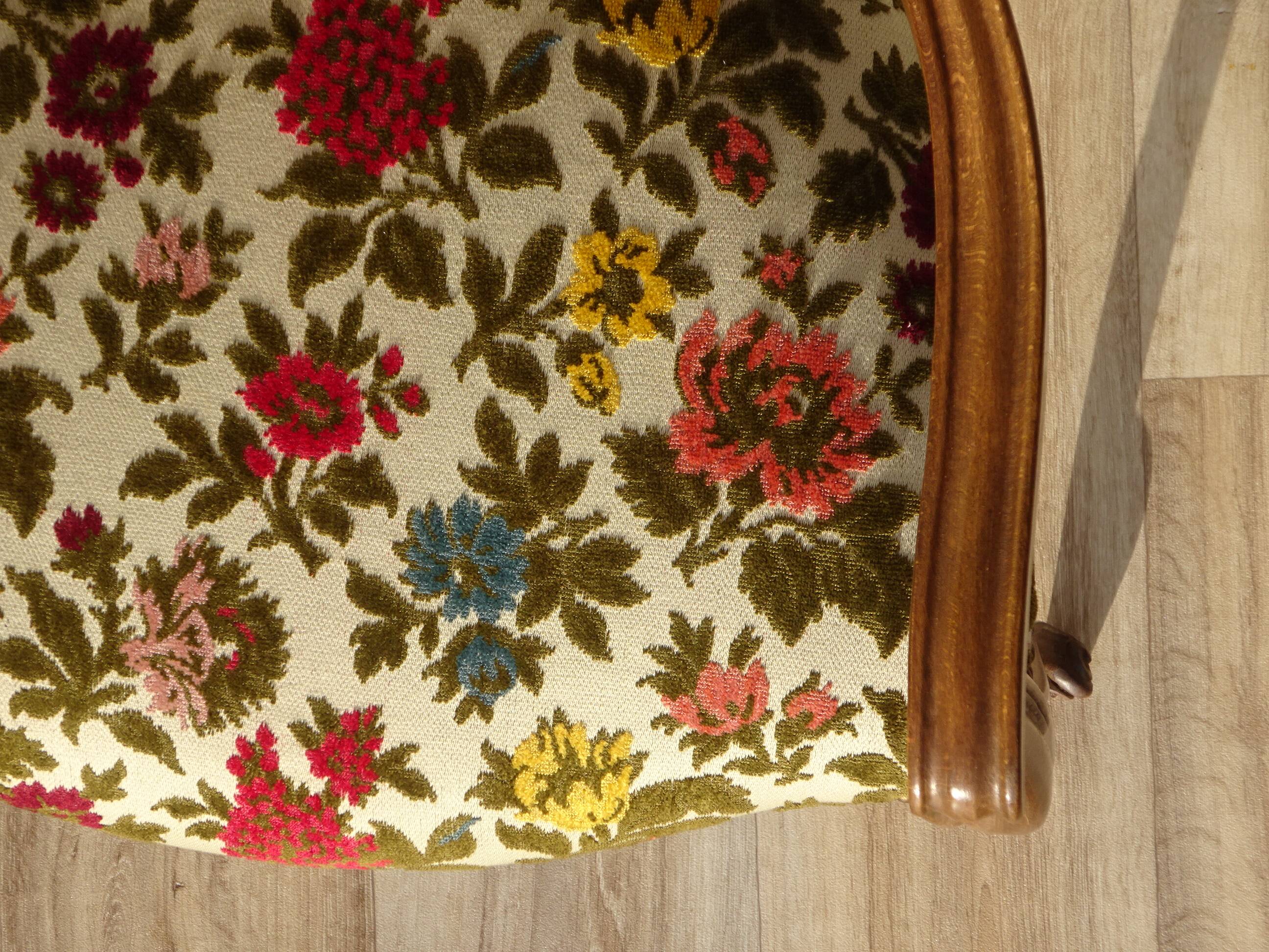 Convertible armchair with brocade fabric and floral patterns.