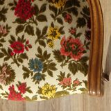 Convertible armchair with brocade fabric and floral patterns.