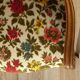 Convertible armchair with brocade fabric and floral patterns.
