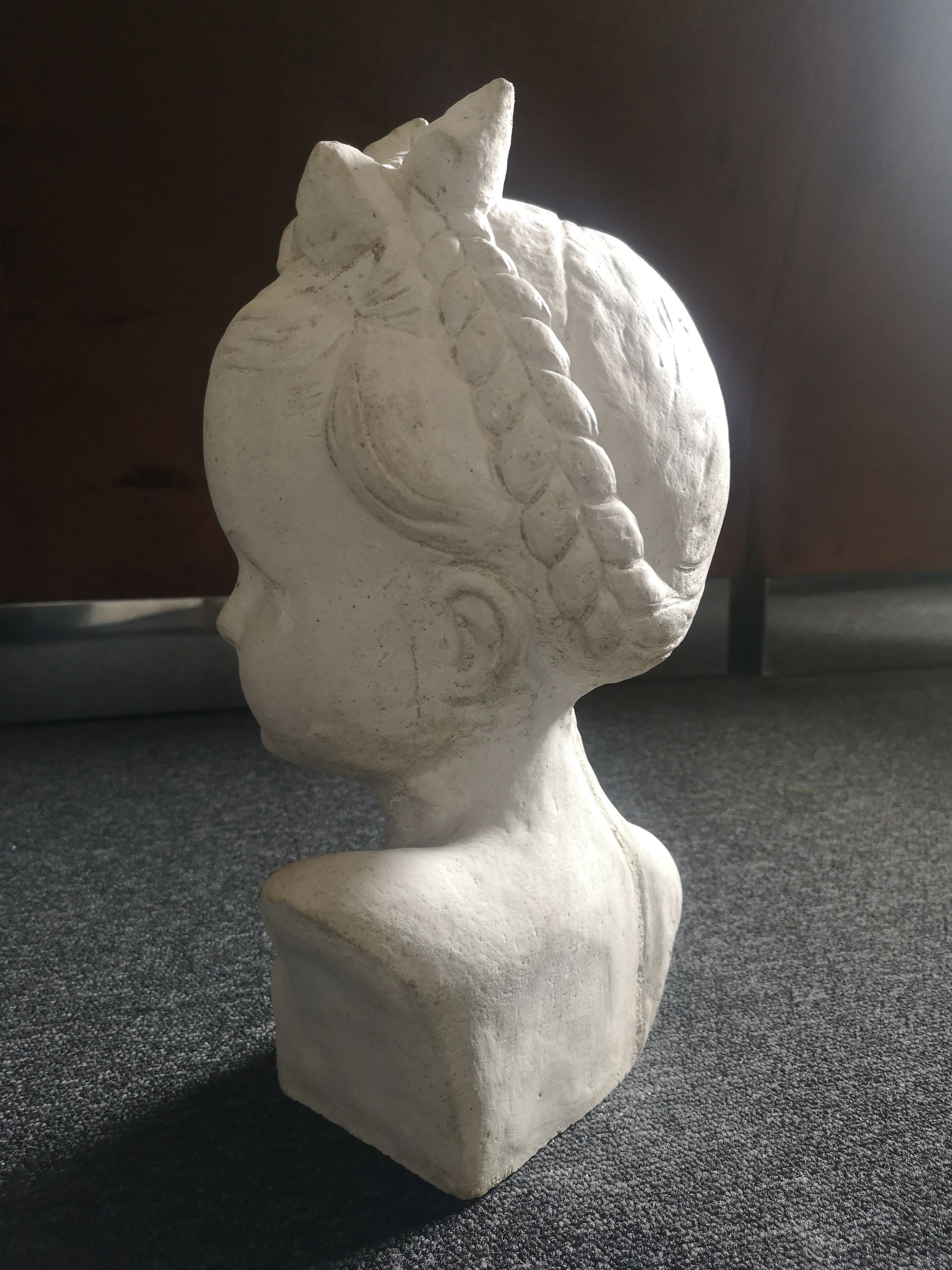 Bust girl in patinated terracotta