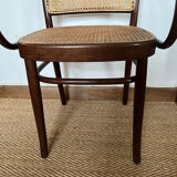 Curved wood and cane armchair