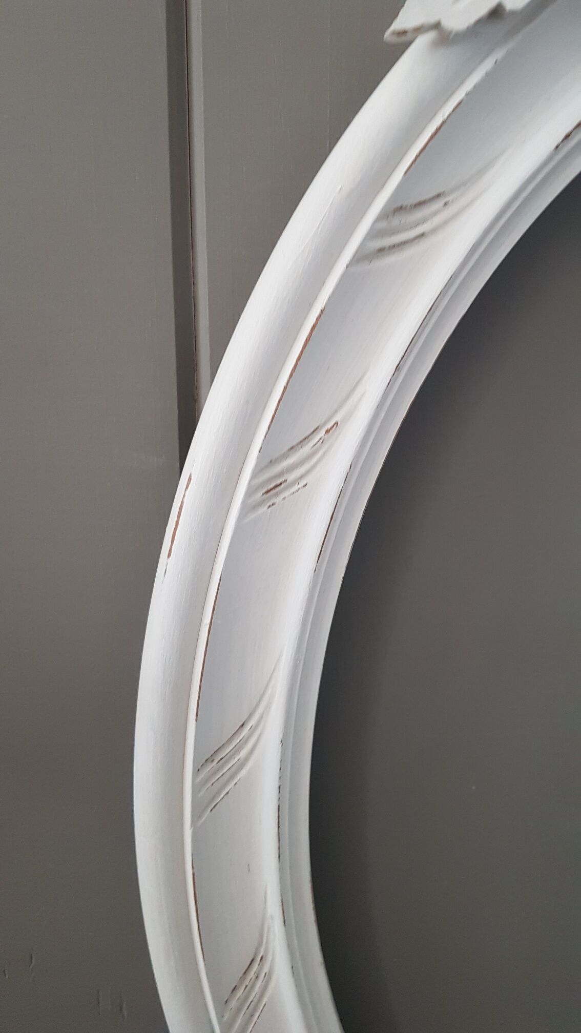 Old oval frame patinated white