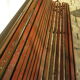 Public bench in wooden slats and cast iron legs