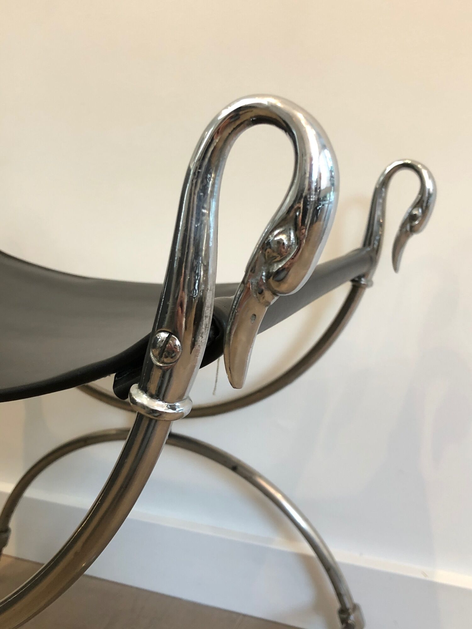Curule stool in silver steel neoclassical style with swan heads