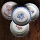 A set of 4 flat plates in pink and blue with Fontanges flowers from Sarreguemines.
