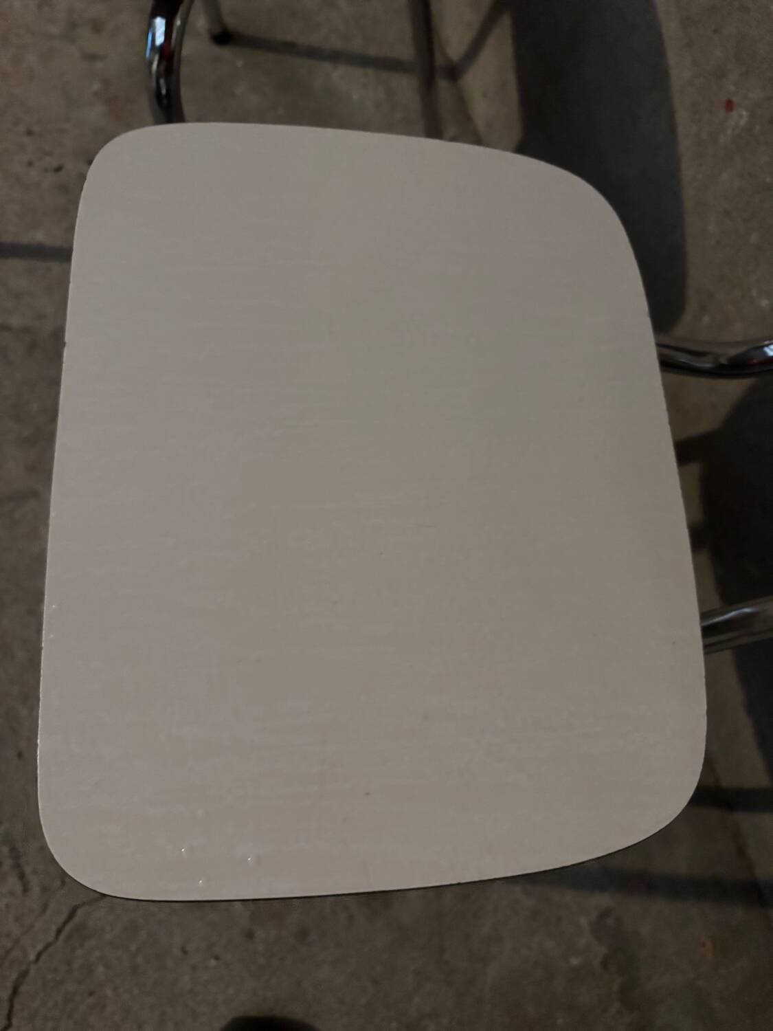 3 white Formica chairs