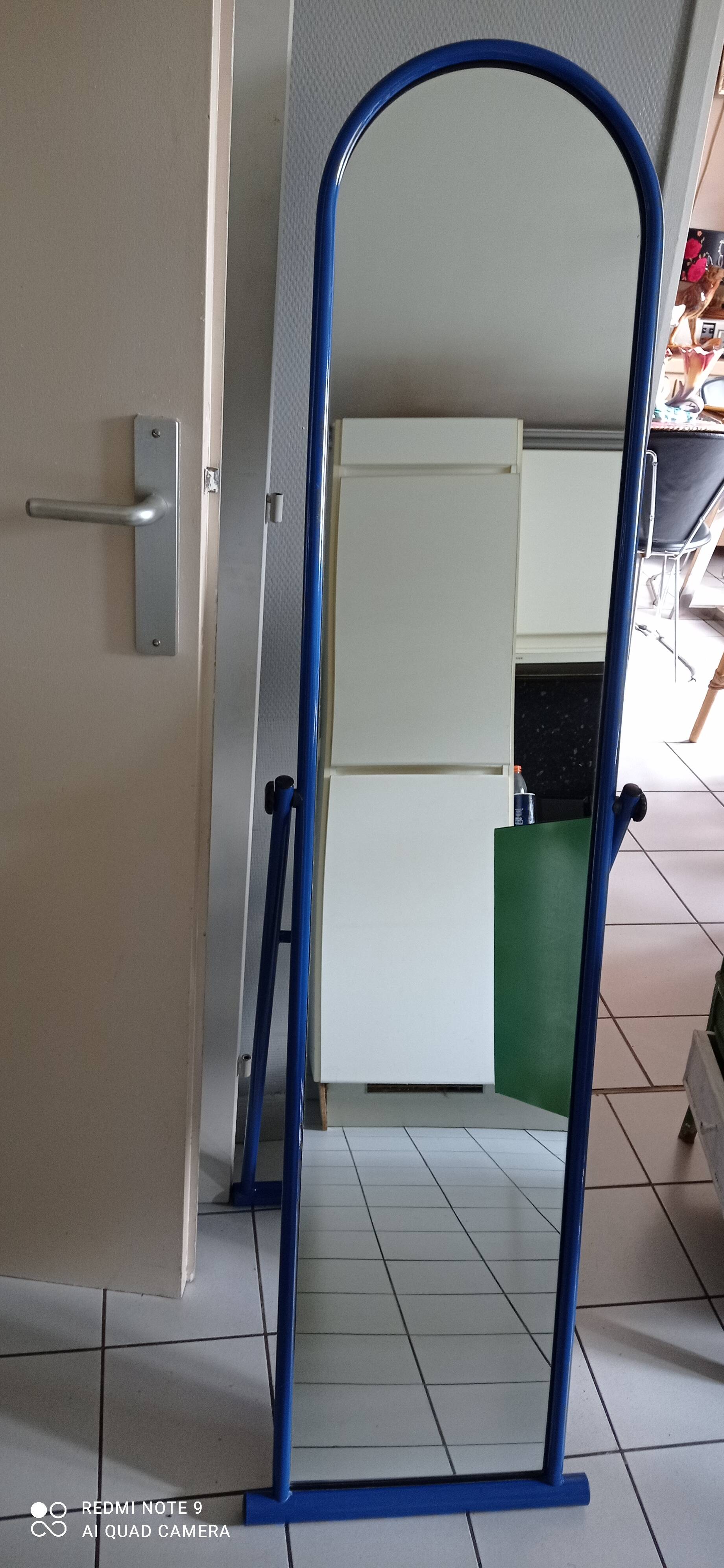 Adjustable mirror on vintage blue tubular structure stand