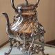 Ancient samovar tea fountain in silver metal