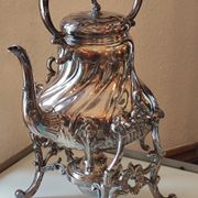 Ancient samovar tea fountain in silver metal
