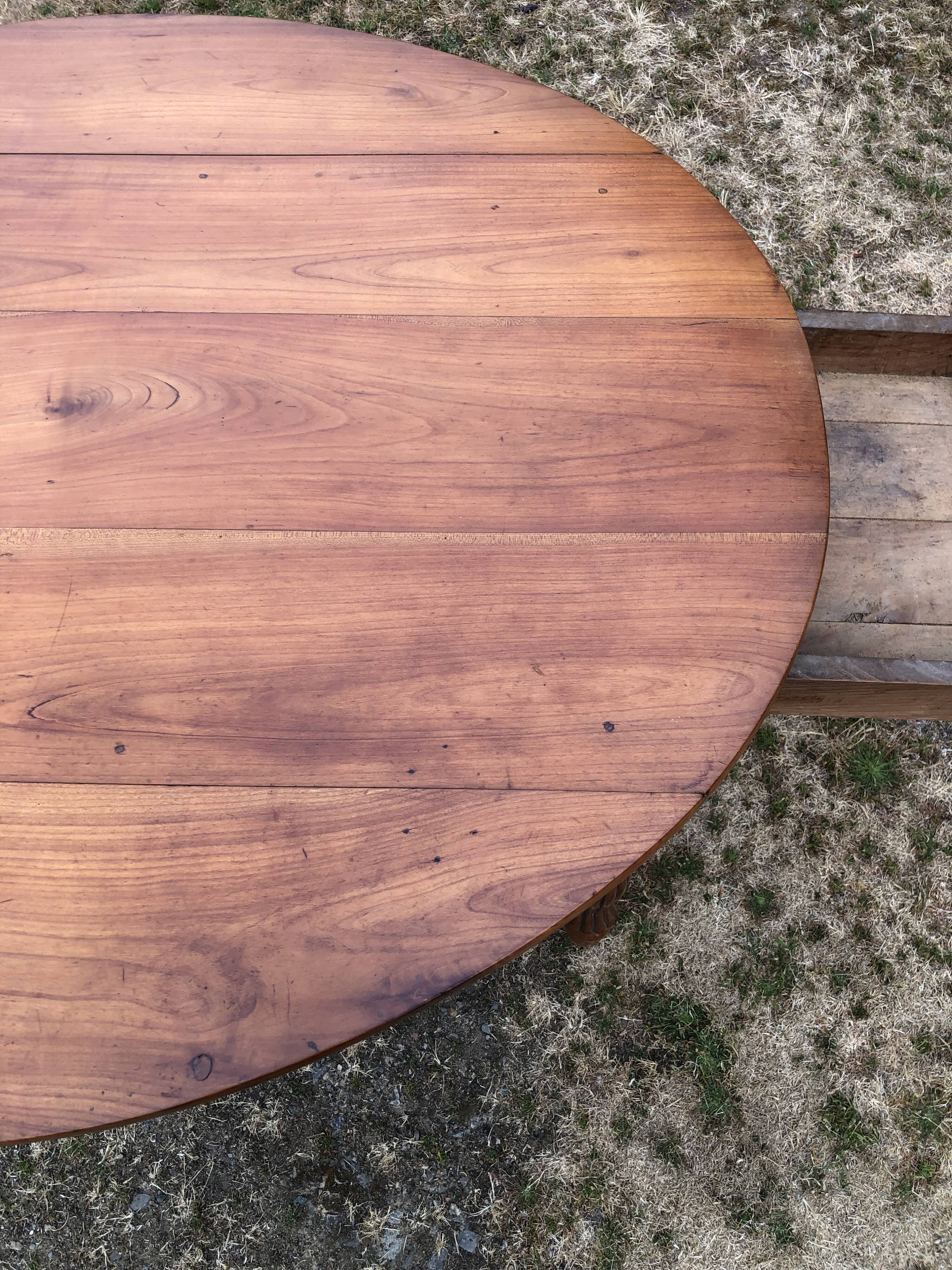 Louis Philippe oval drop-leaf table in solid cherry wood with 2 drawers.