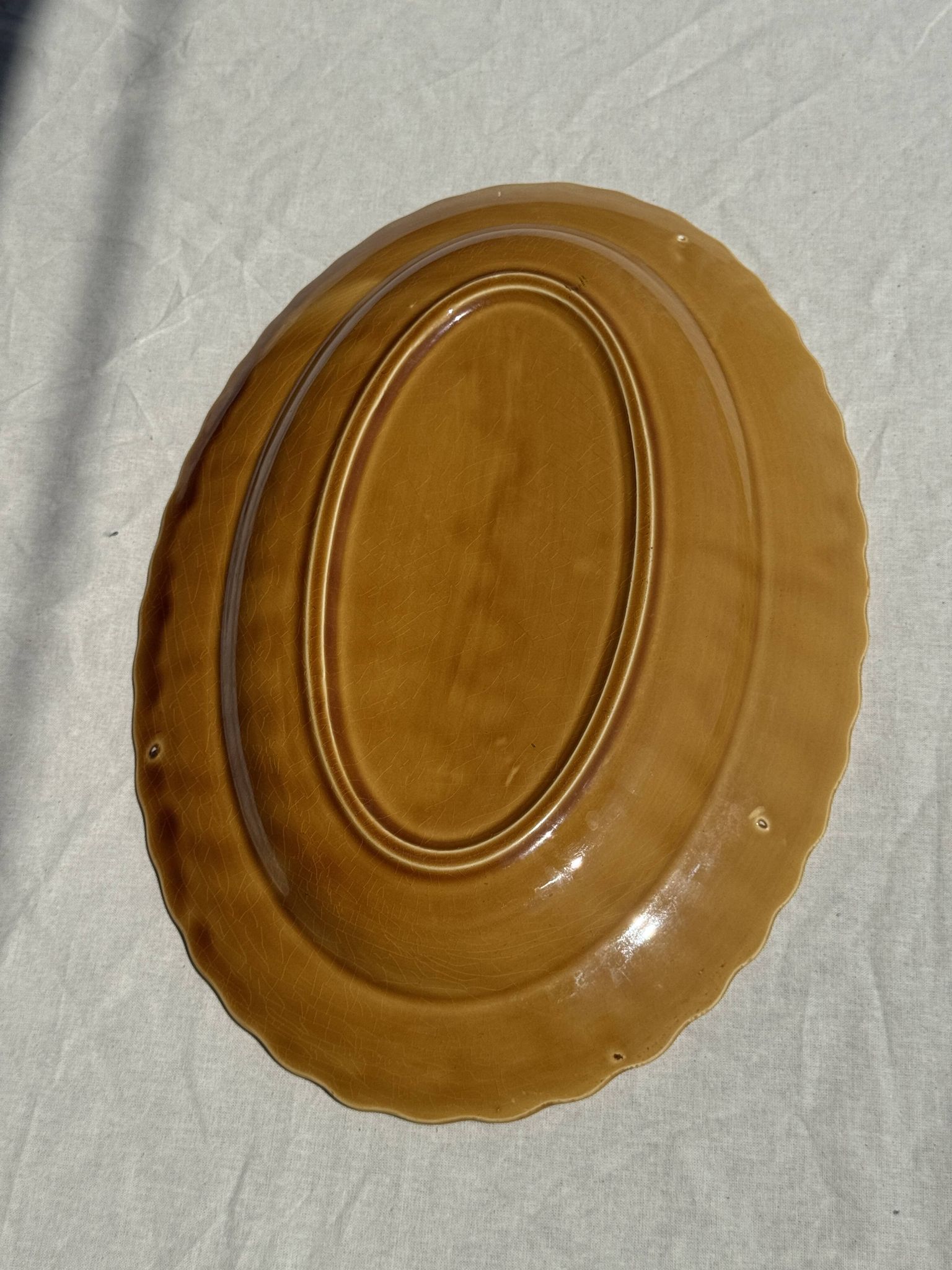 Antique oval dish, yellow-orange, frieze border L:24