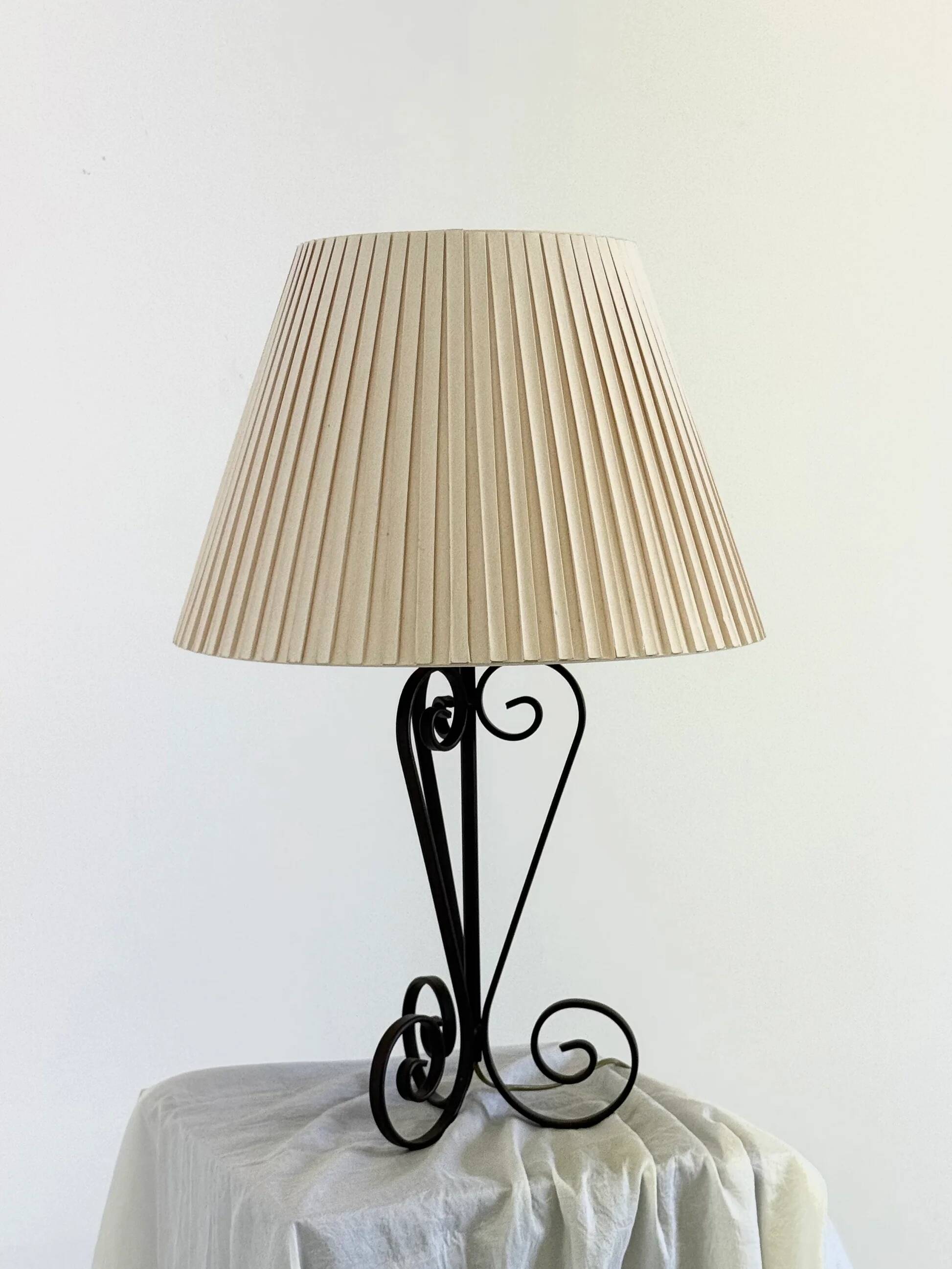 Vintage wrought iron table lamp in swirl shape with pleated shade