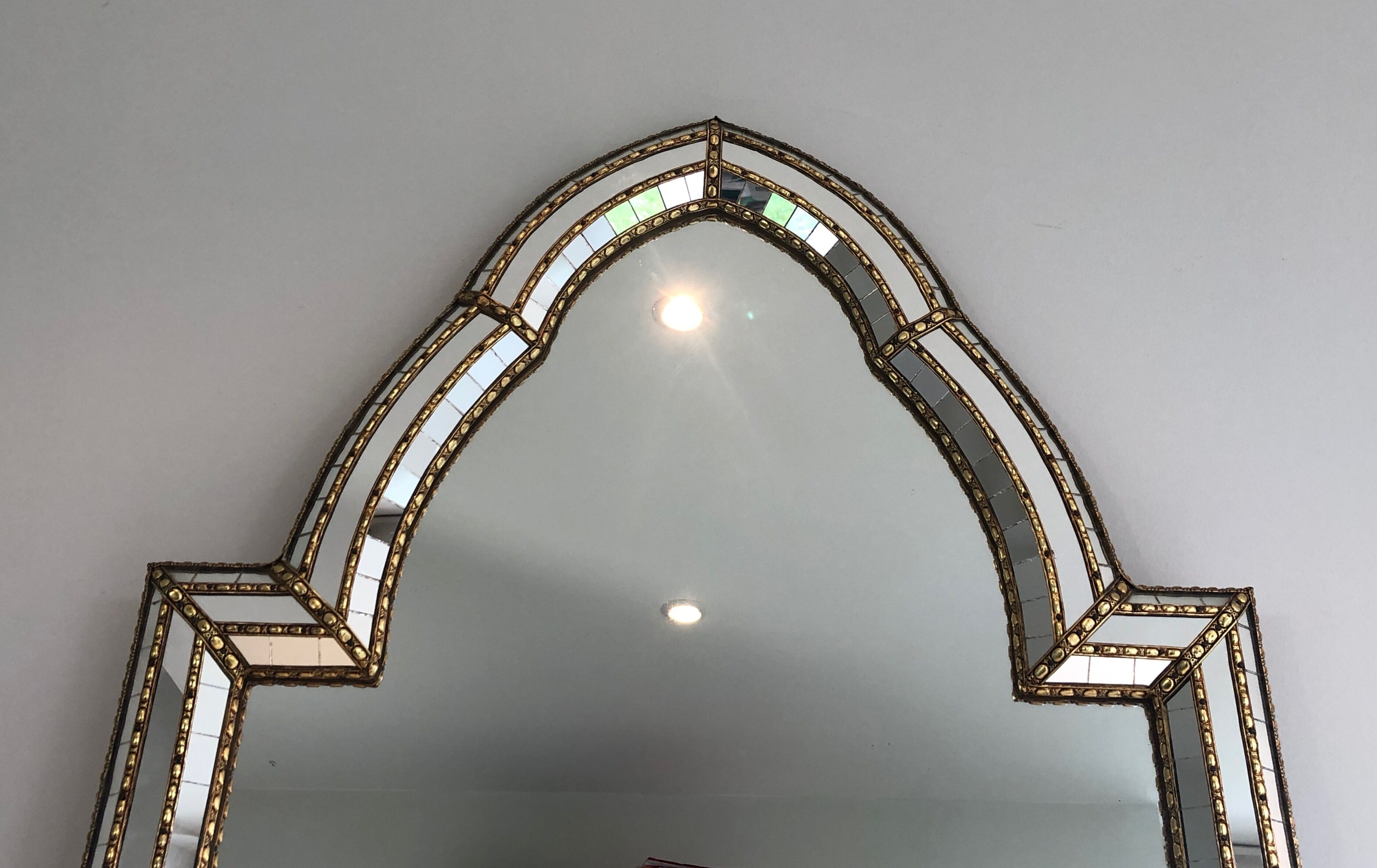 Mirror consisting of multi-faceted mirrors and brass garlands, French work, around 1970