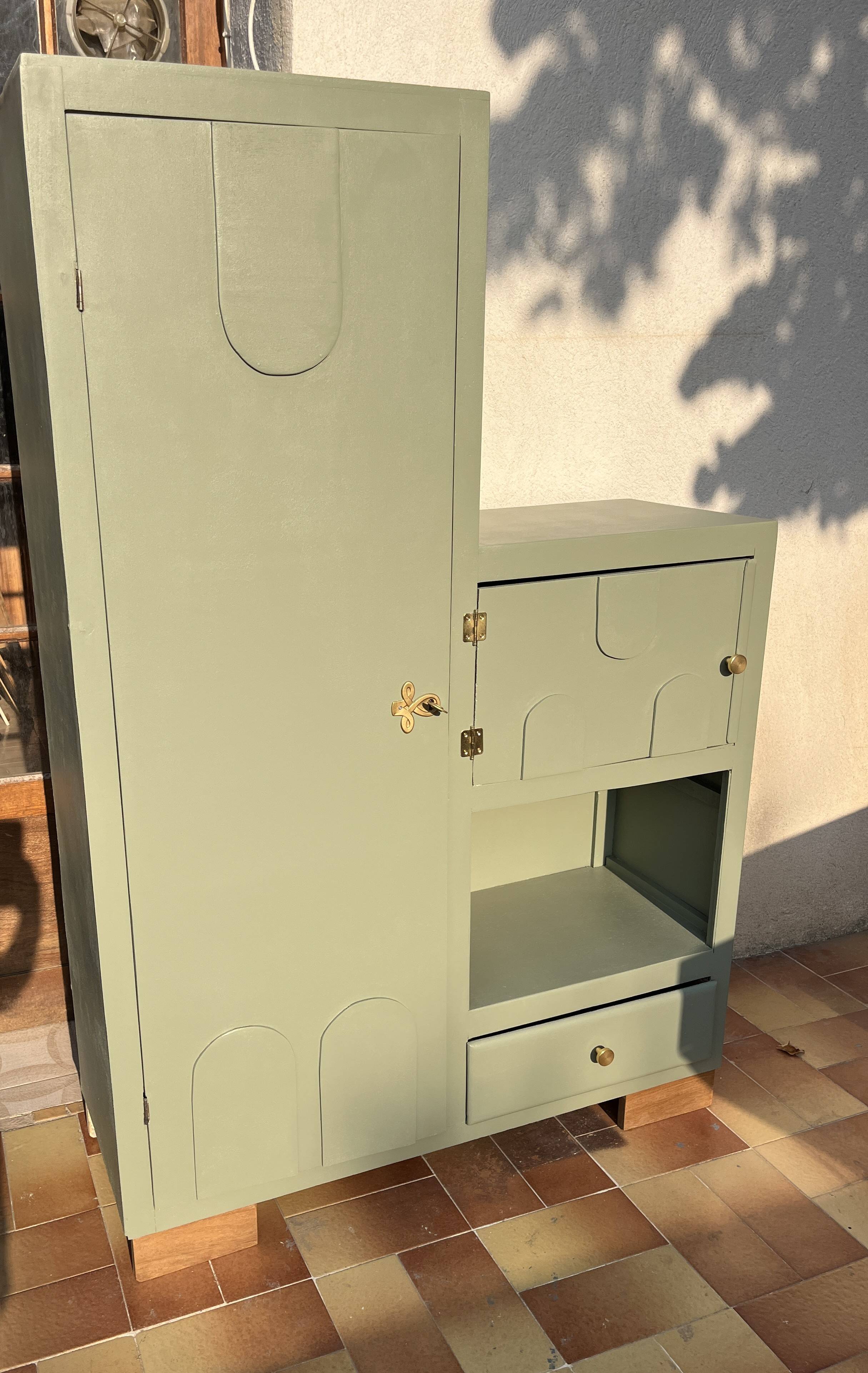 Asymmetrical vintage wardrobe painted in green.