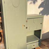 Asymmetrical vintage wardrobe painted in green.
