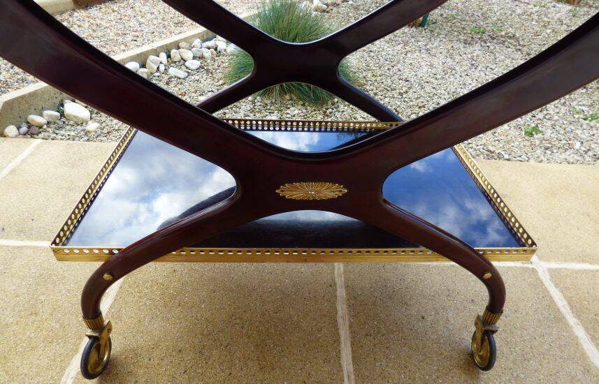Chic serving table on wheels from the 60s with brass decorations and two shelves.
