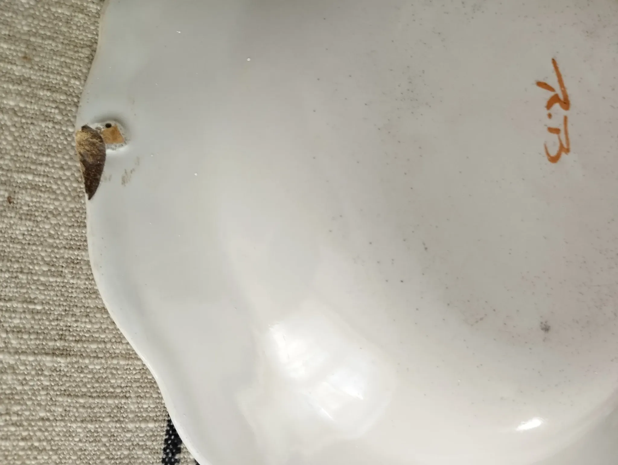 Pair of antique plates with a bird of paradise design in the style of Moustiers.