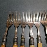 Old silver fish forks with bone handles