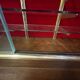 Large vintage display cabinet in wood and glass – red background, 15 shelves