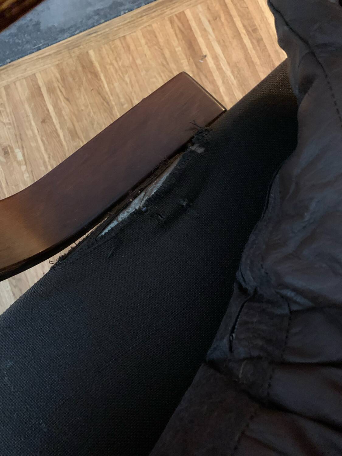 Vintage leather armchair with wooden armrests