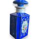 Perfume bottle in porcelain of old paris blue background