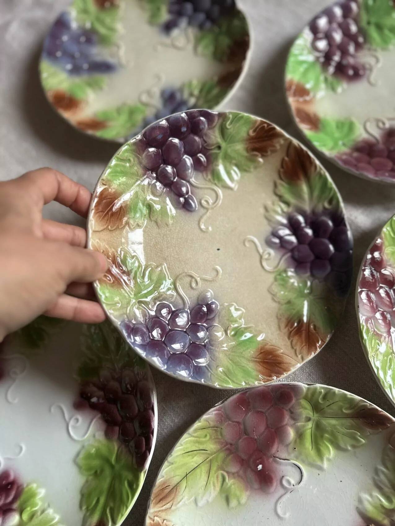 Set of eight flat dessert plates in barbotine earthenware with grape decoration – circa 1900.