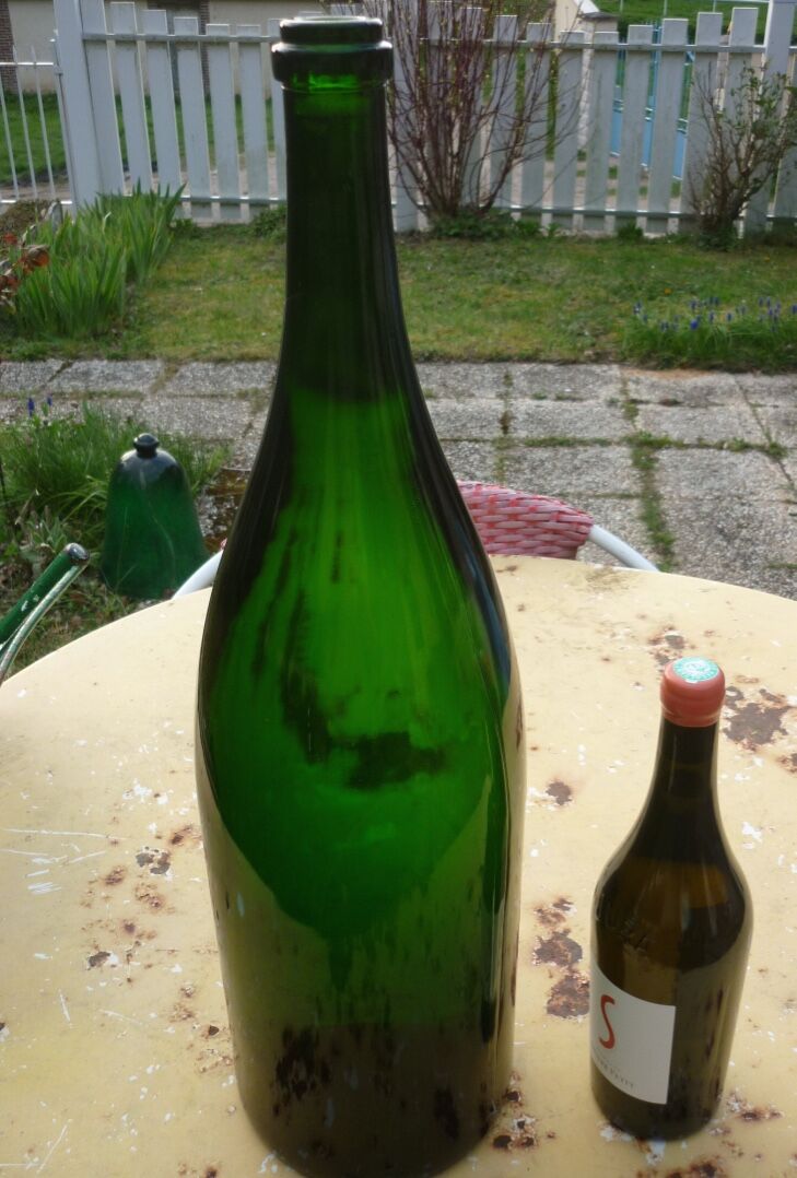 Green blown glass bottle of 58 cm.