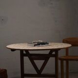 19th-century French round wine table with an adjustable top and floral textile surface.