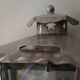 Half grey metal wall sconce and 3 windows