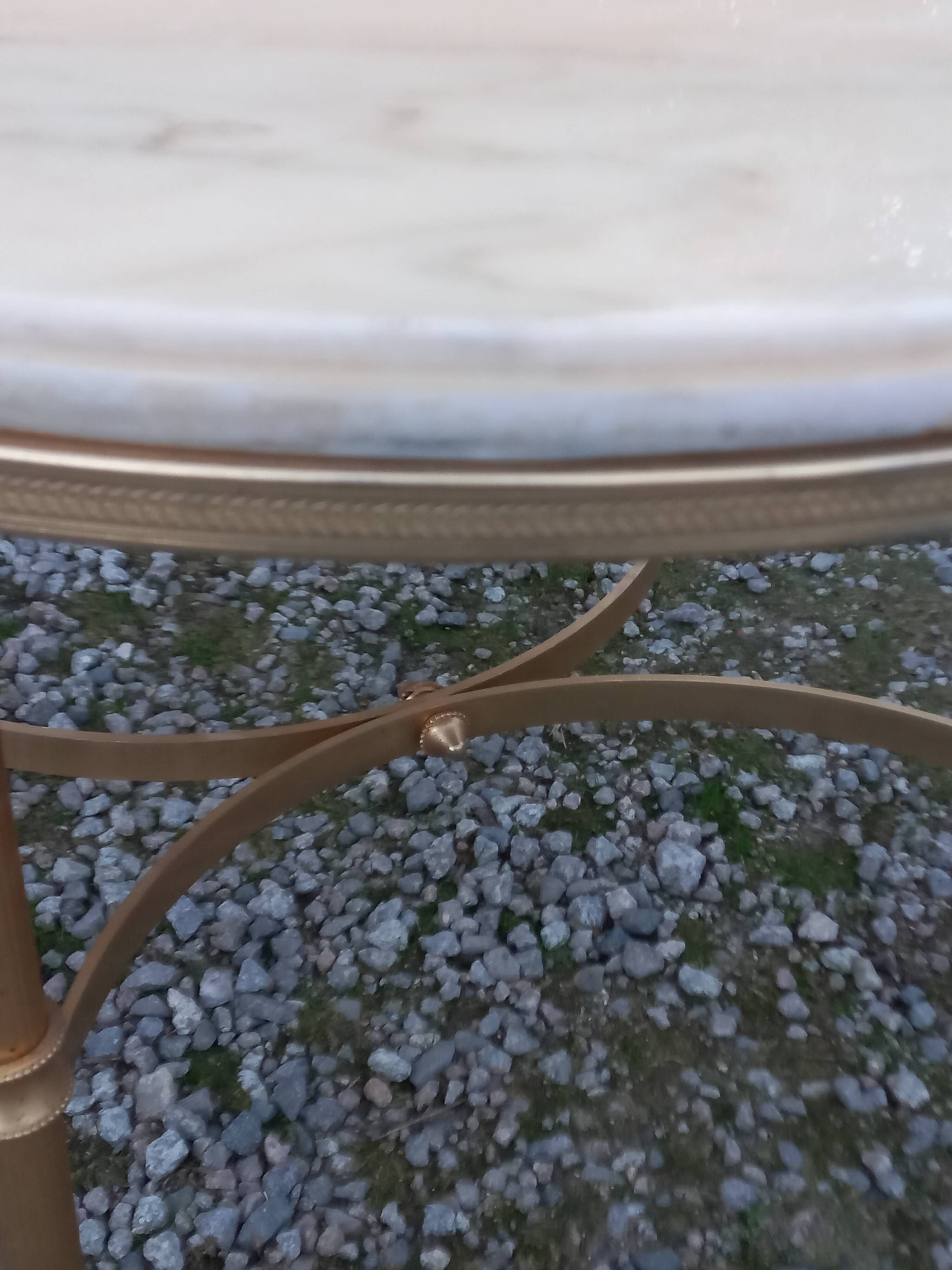 Round neoclassical coffee table with a marble top and golden metal base.