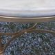 Round neoclassical coffee table with a marble top and golden metal base.