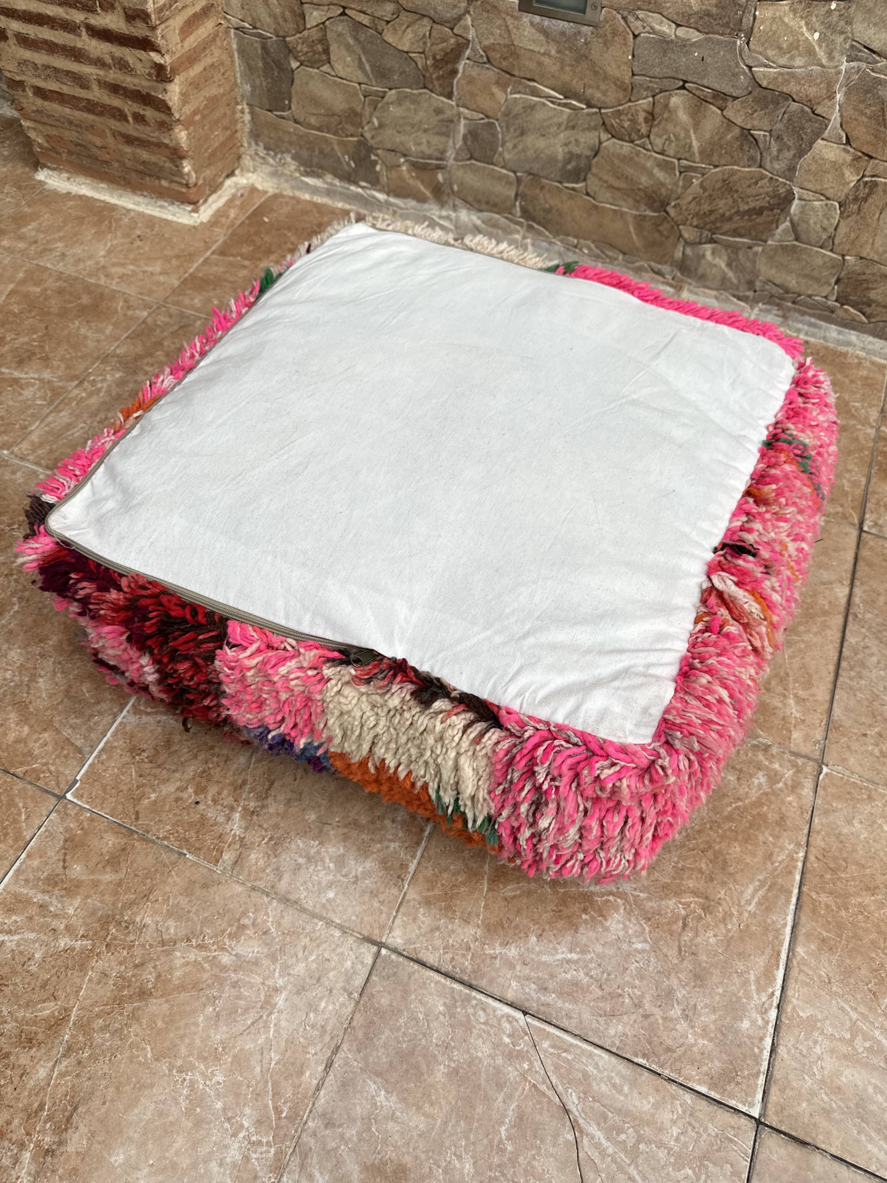 Berber floor pouf: Handwoven Moroccan wool cushion.
