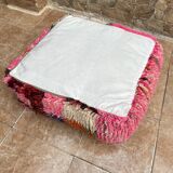 Berber floor pouf: Handwoven Moroccan wool cushion.