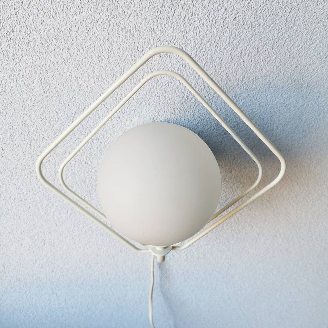 Metal applique with 80s glass sphere