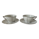 Two Art Deco porcelain cups and saucers with silver trim.