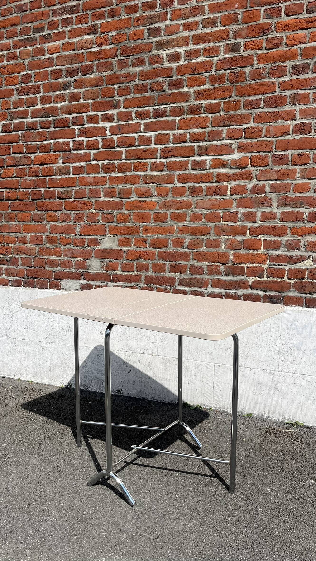 Folding table with chrome and pink formica.