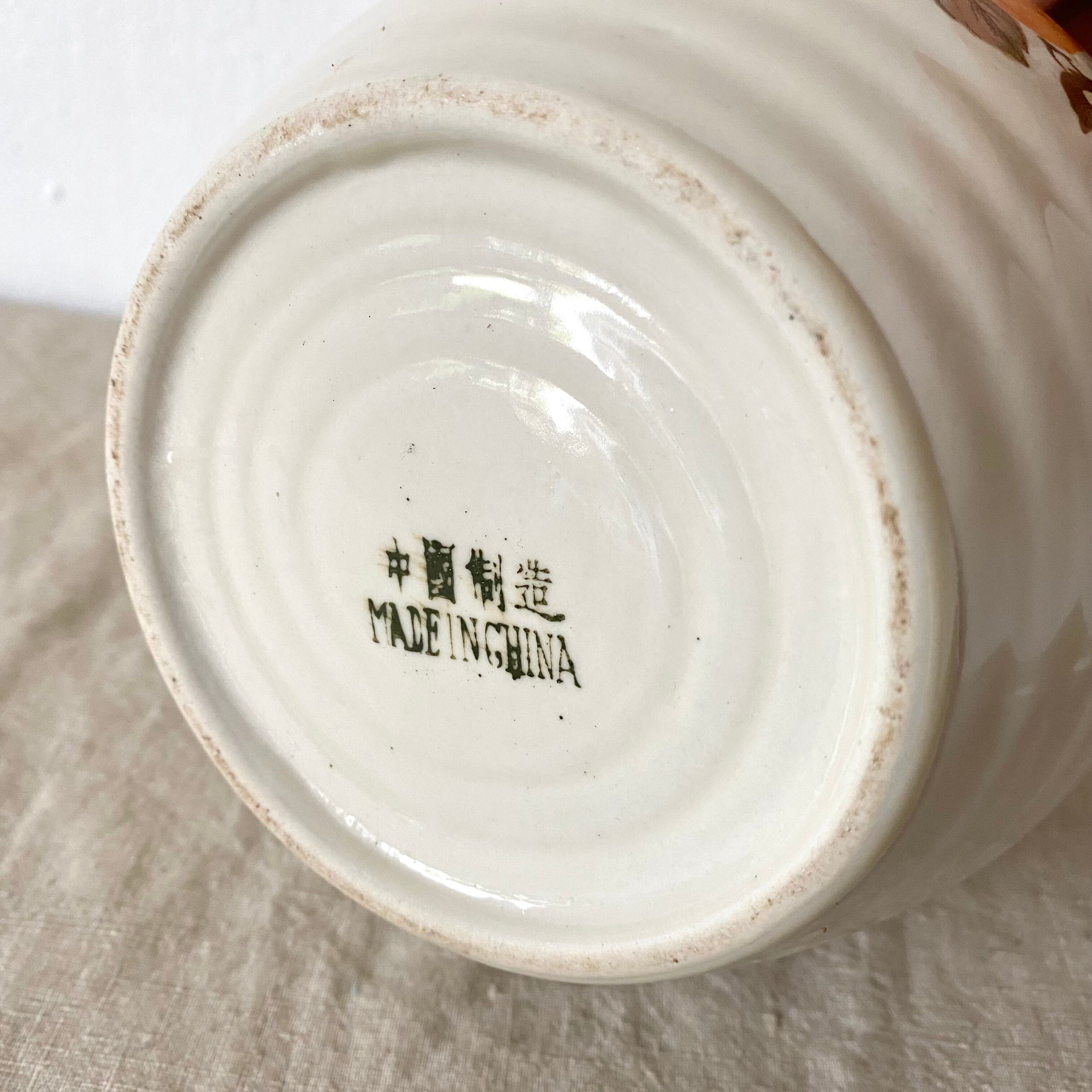 Vintage porcelain and rattan teapot