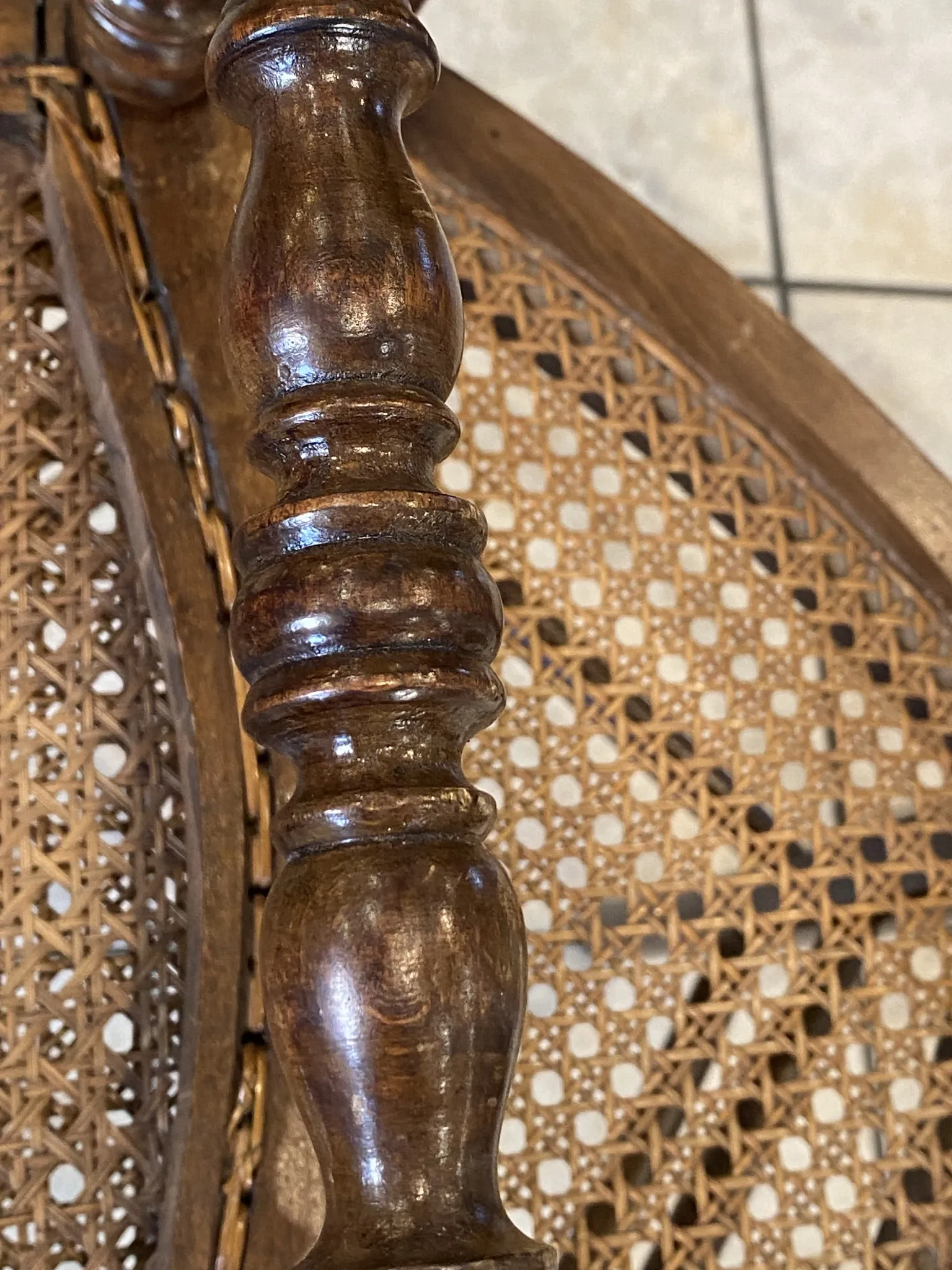 Pair of antique caned and wooden chairs from the 1900s.
