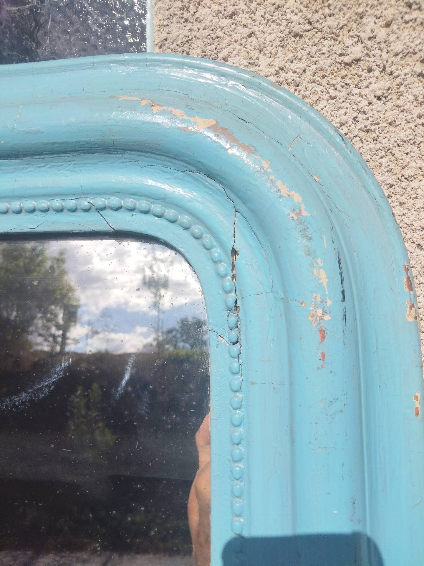 Large Louis-Philippe mirror from the 19th century in wood and stucco with a turquoise blue patina.