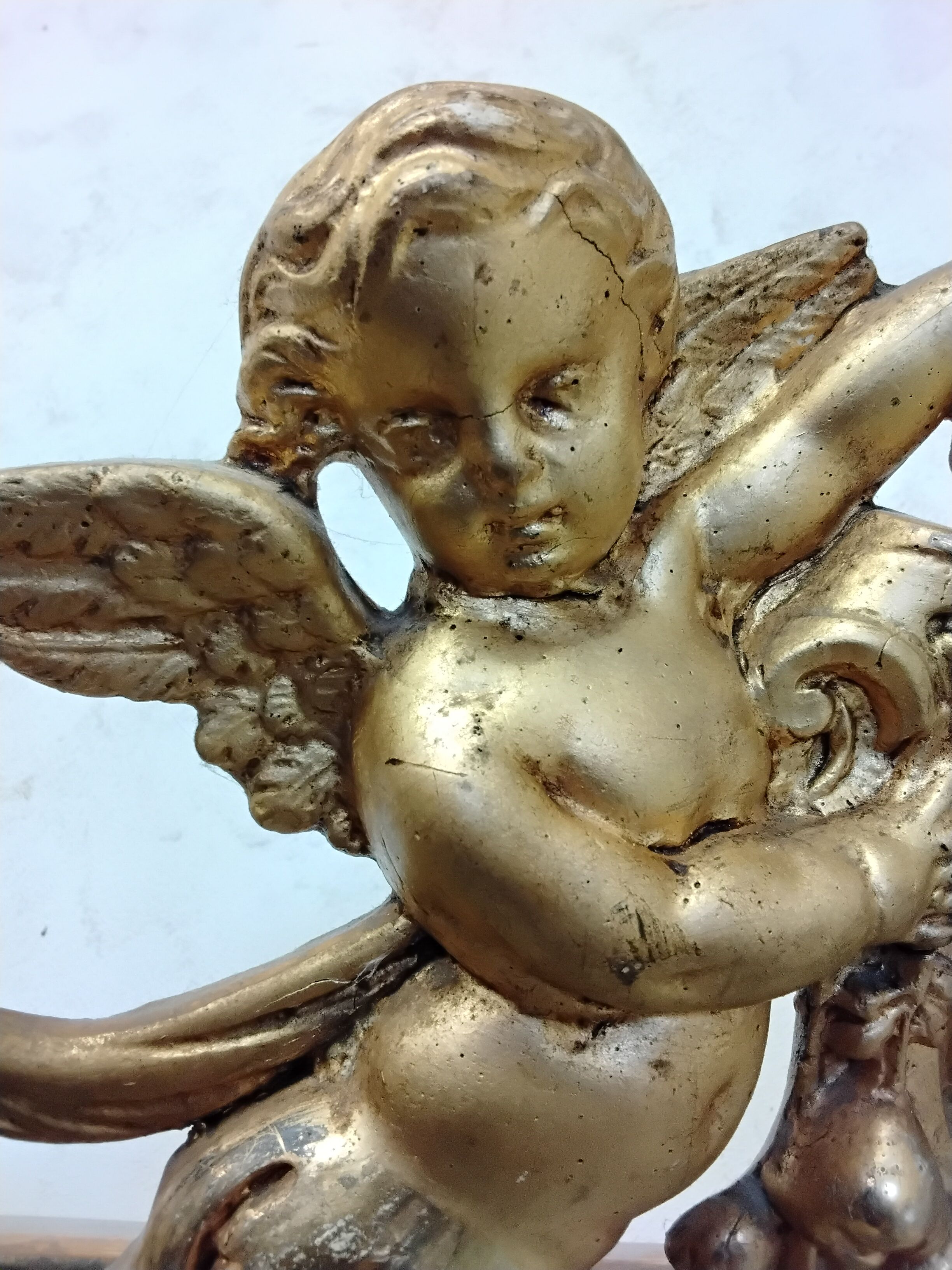 Antique mirror with a gilded frame and cherubs.