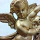 Antique mirror with a gilded frame and cherubs.