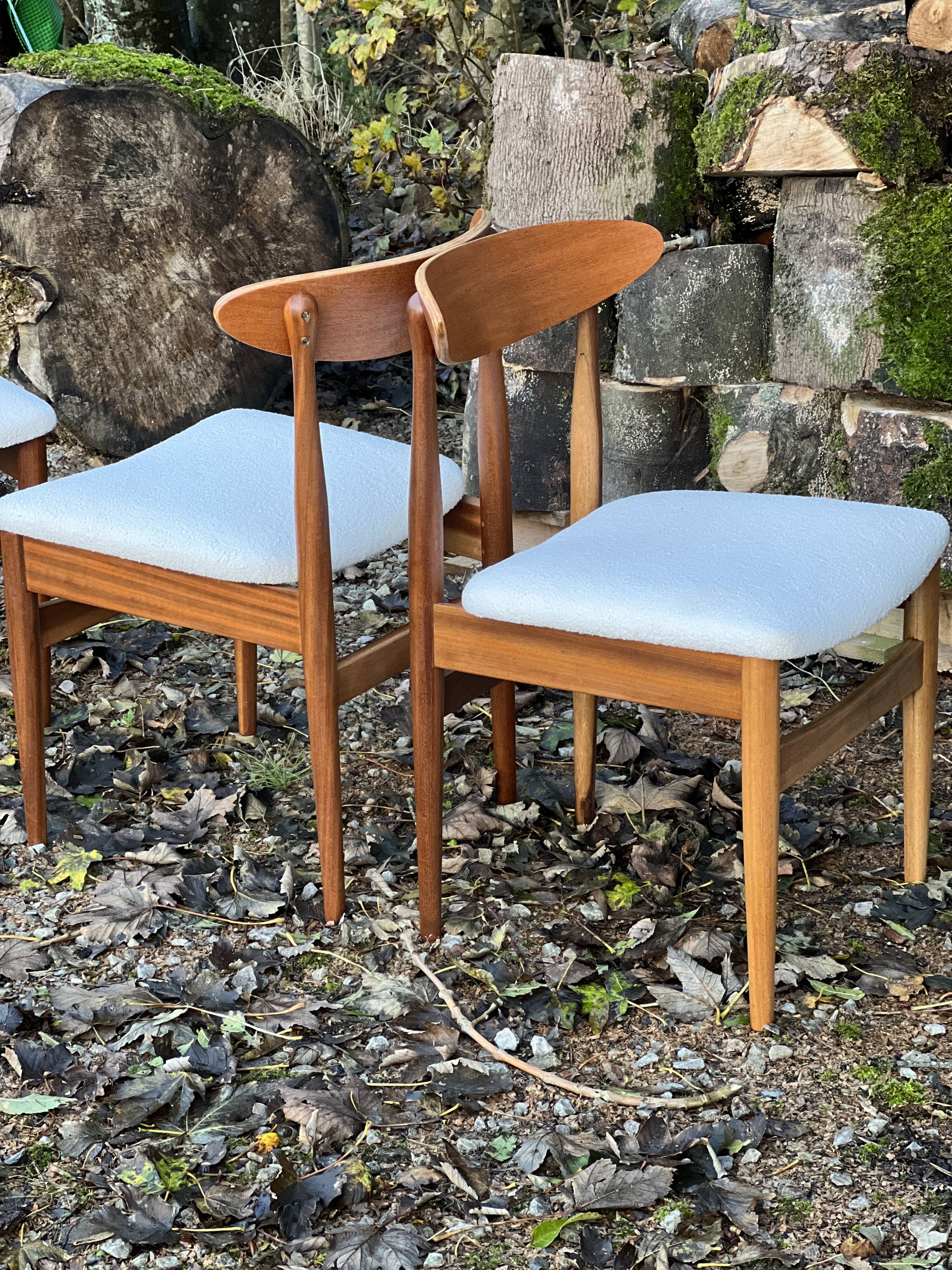 A set of GPlan chairs in teak with a white woolly fabric