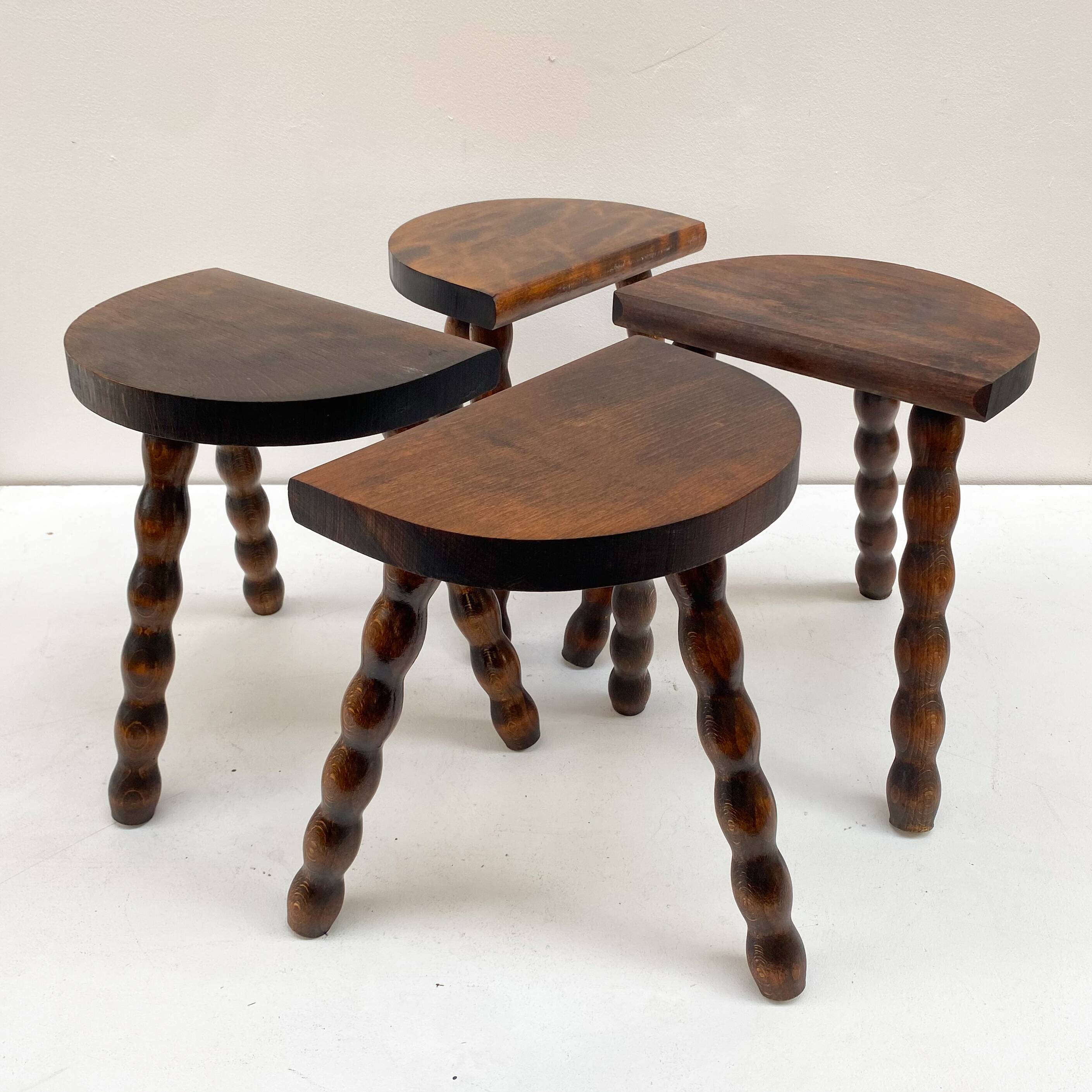 Series of 4 small tripod stools with half-moon seat and beaded turned wood legs