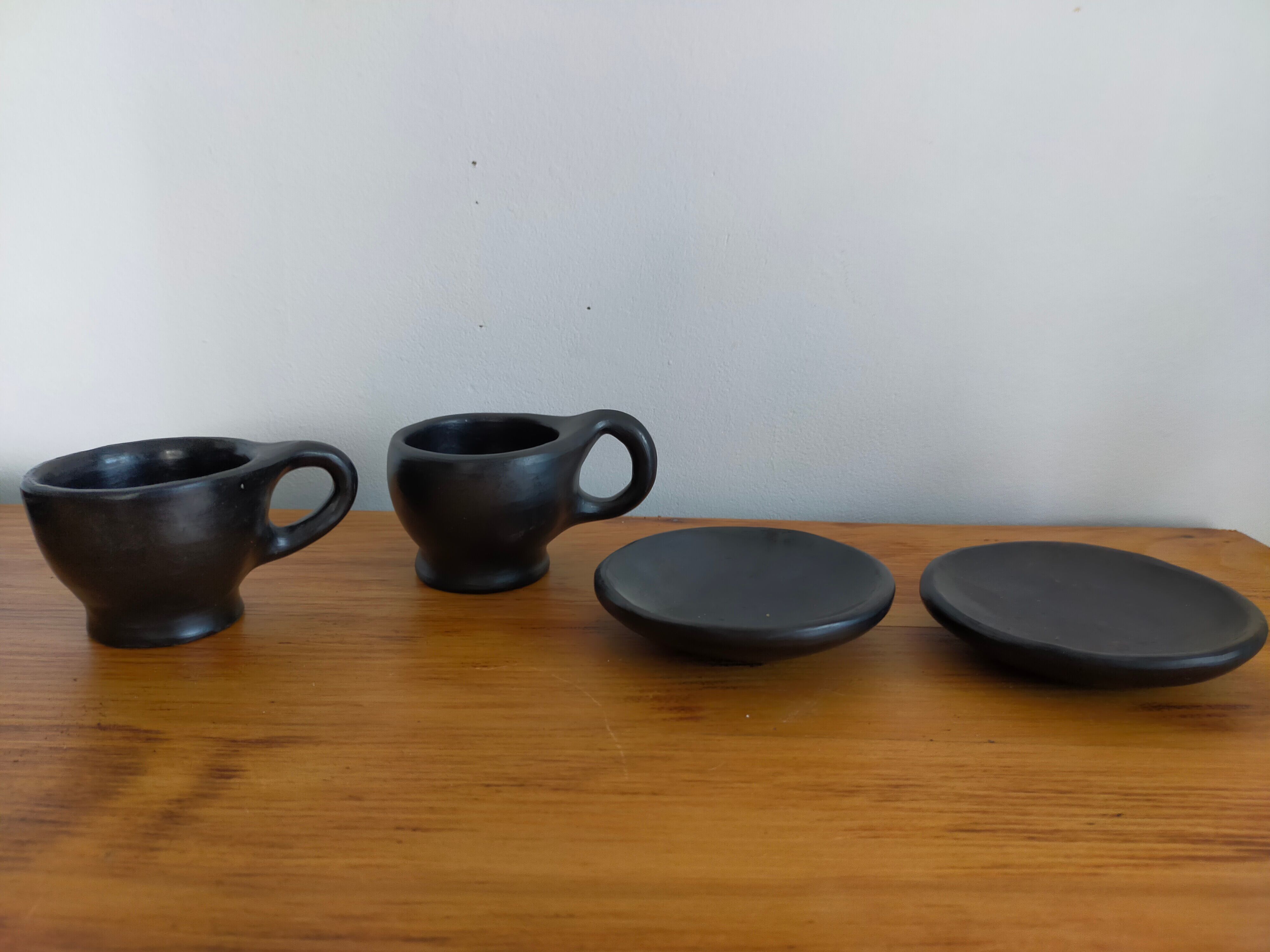 Terracotta service painted in black saucer cups and top