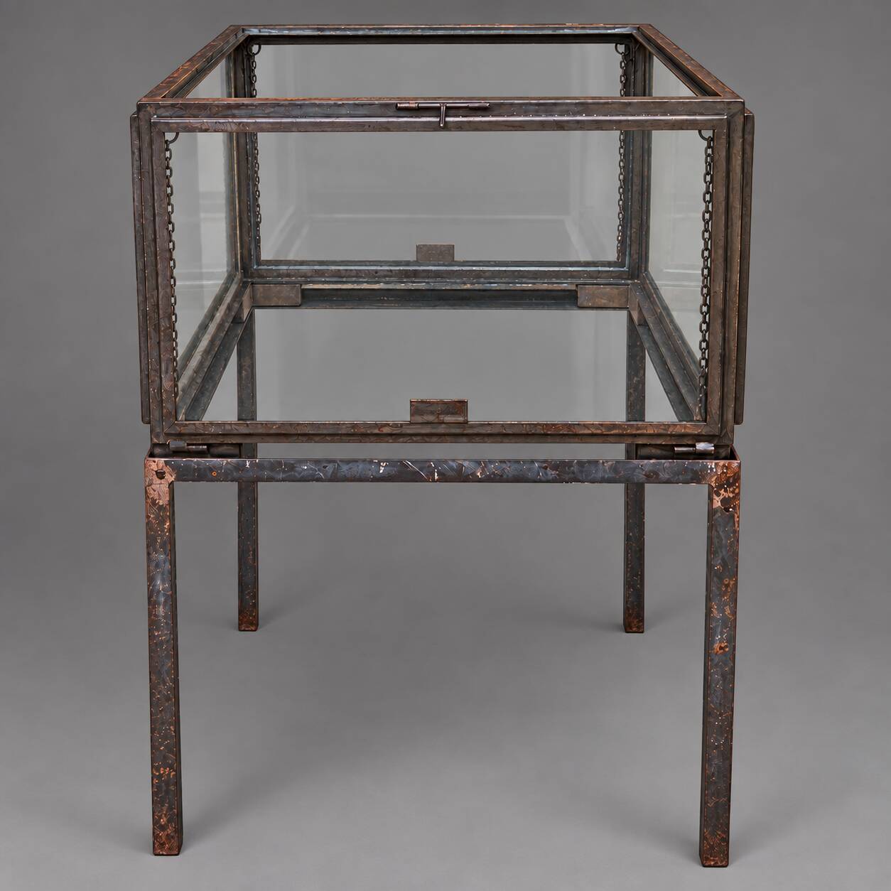 A showcase made of steel and glass, mounted on a custom-made steel base.
