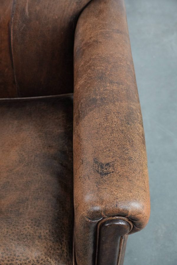 Beautiful vintage sheep leather armchair with a characterful appearance