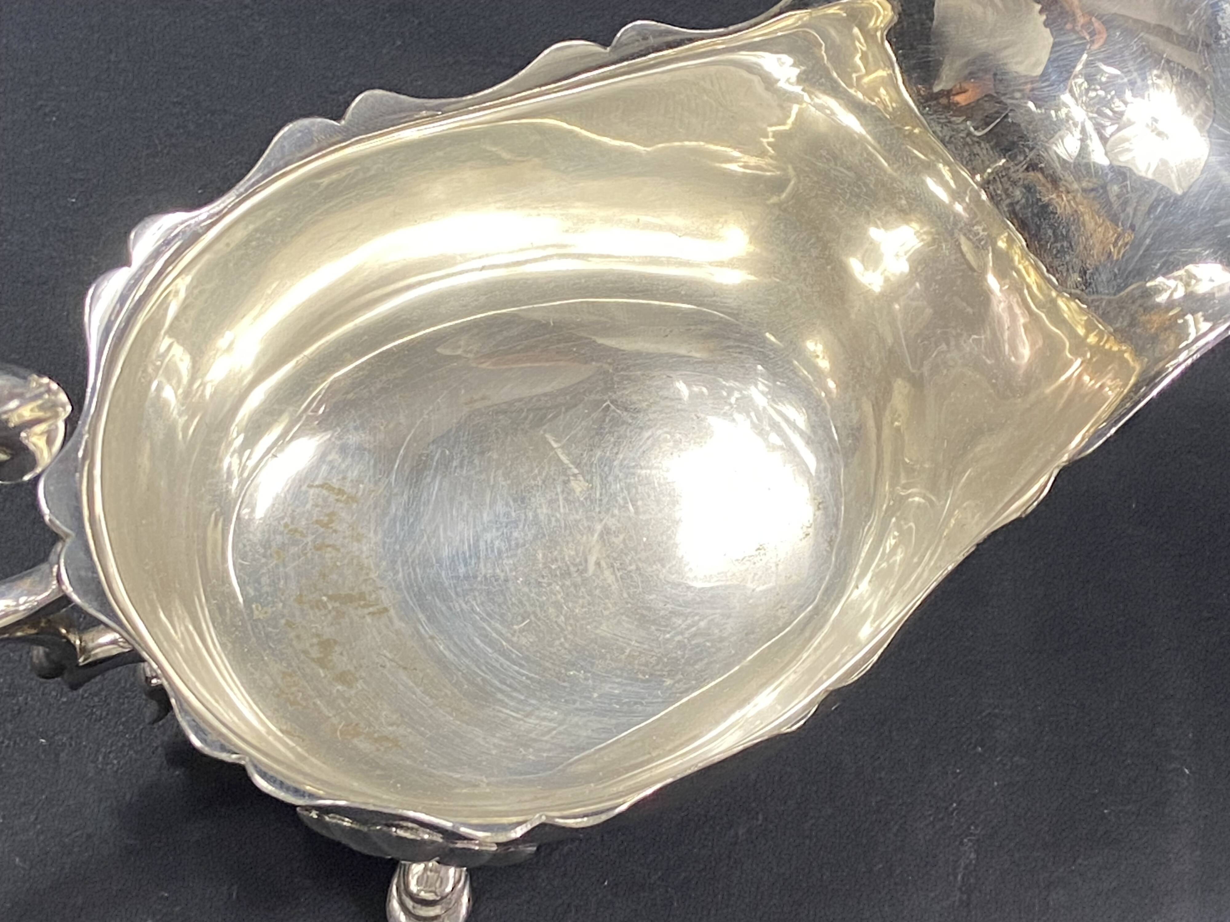 English George III style silver plated tripod sauce boat