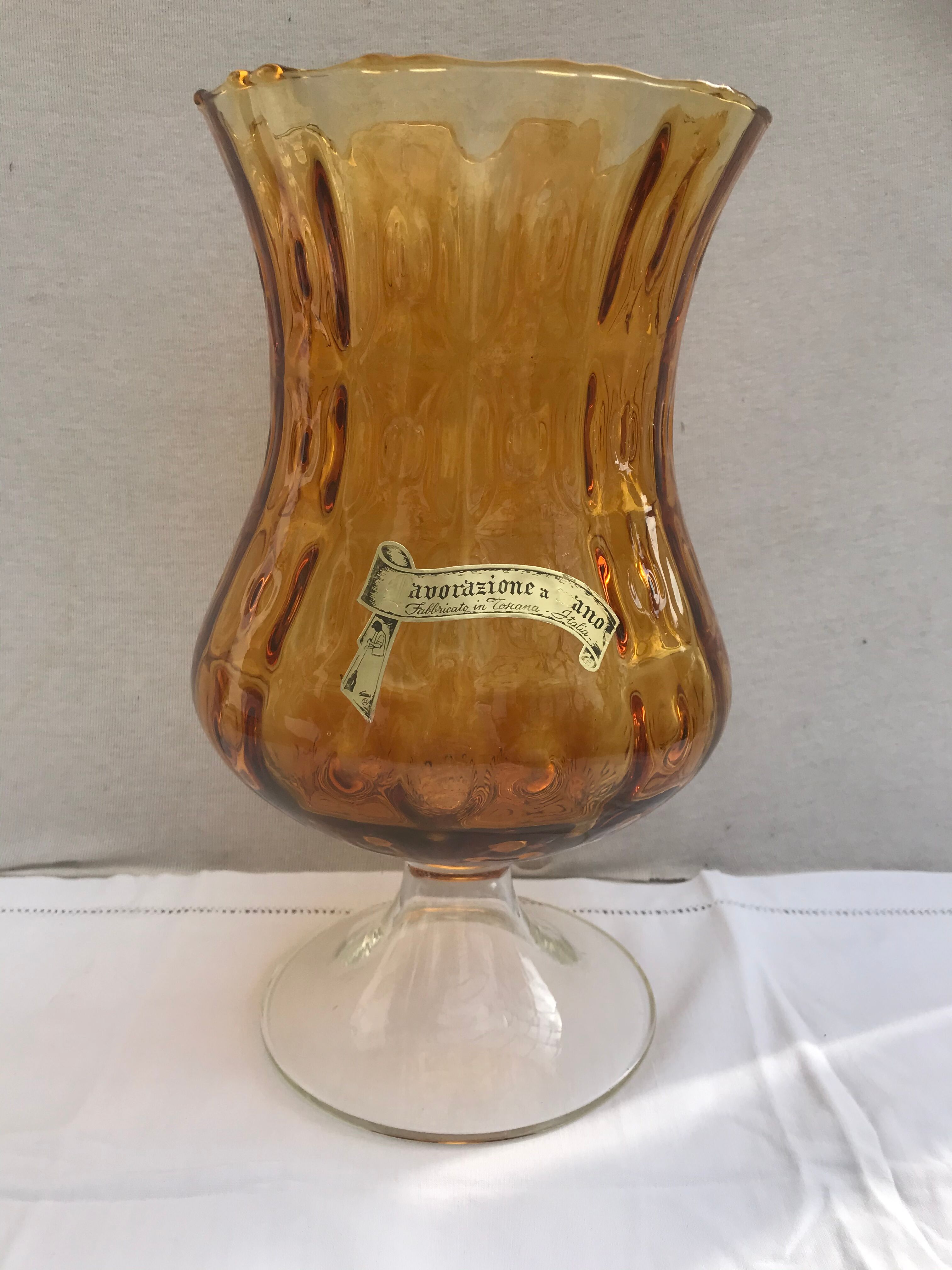 Ancient vase on foot orange glass