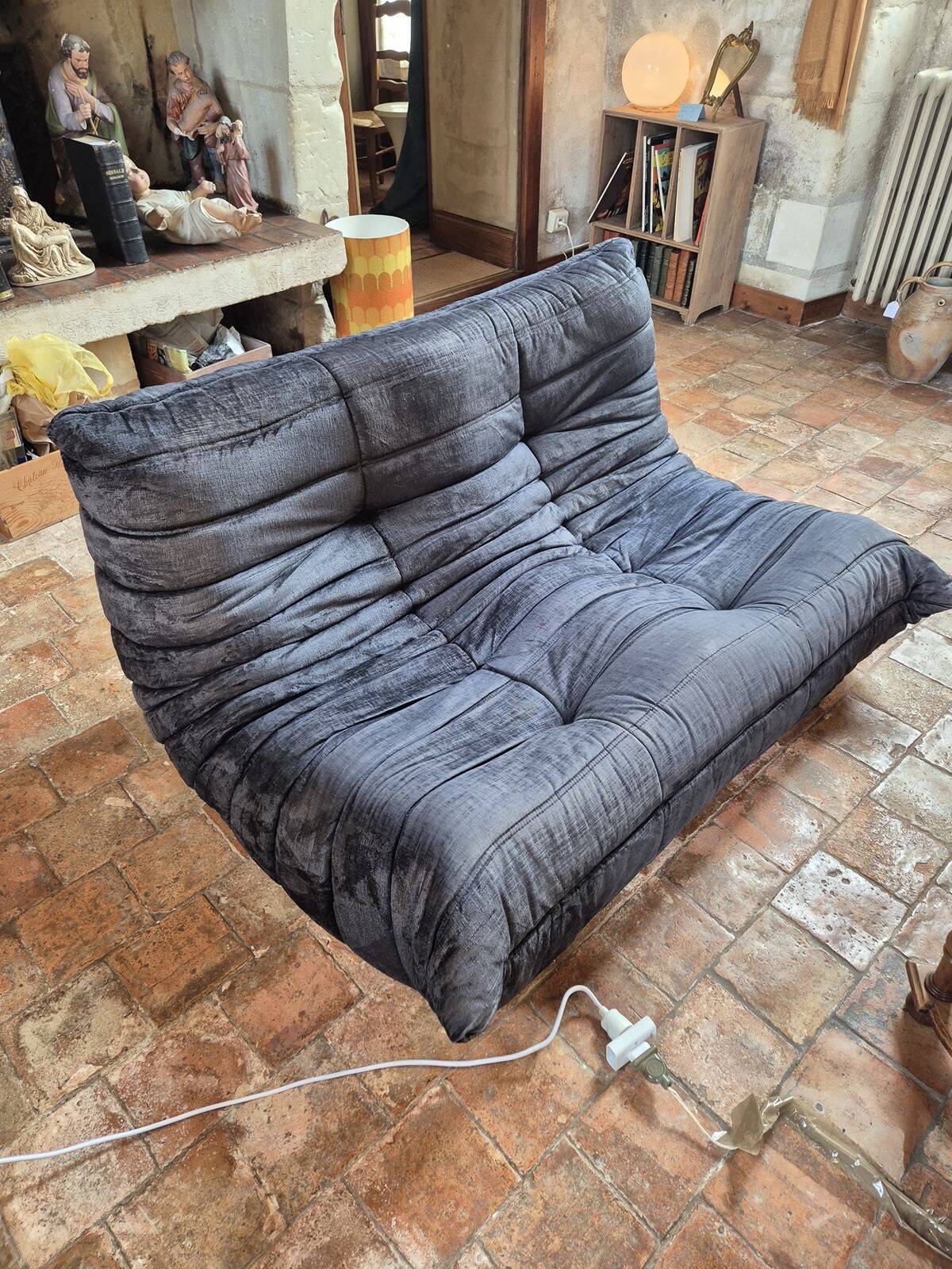 Togo sofa by Ligne Roset and its pouf from the 1970s.